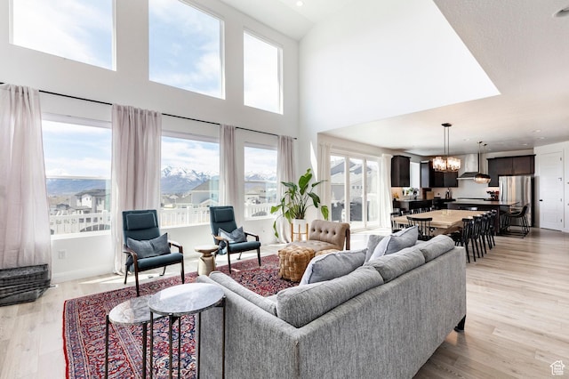 809 N 1490 E, Heber City, UT 84032 - living area with a chandelier, healthy amount of natural light, light wood-type flooring, a high ceiling, and recessed lighting