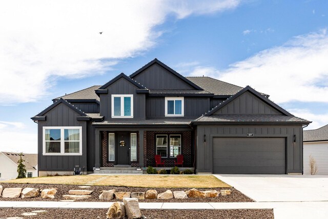 809 N 1490 E, Heber City, UT 84032 - view of front facade with board and batten siding, an attached garage, concrete driveway, and covered porch