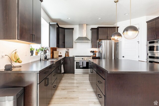 809 N 1490 E, Heber City, UT 84032 - kitchen featuring wall chimney range hood, appliances with stainless steel finishes, dark countertops, a sink, and recessed lighting
