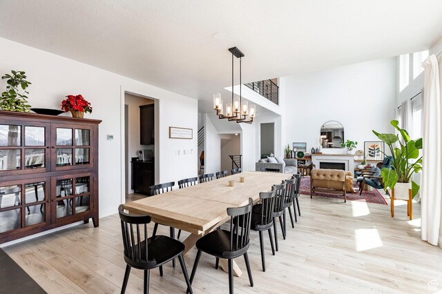809 N 1490 E, Heber City, UT 84032 - dining area featuring light wood finished floors, a chandelier, and a fireplace