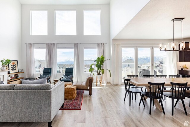 809 N 1490 E, Heber City, UT 84032 - living area with a towering ceiling, a chandelier, and light wood finished floors