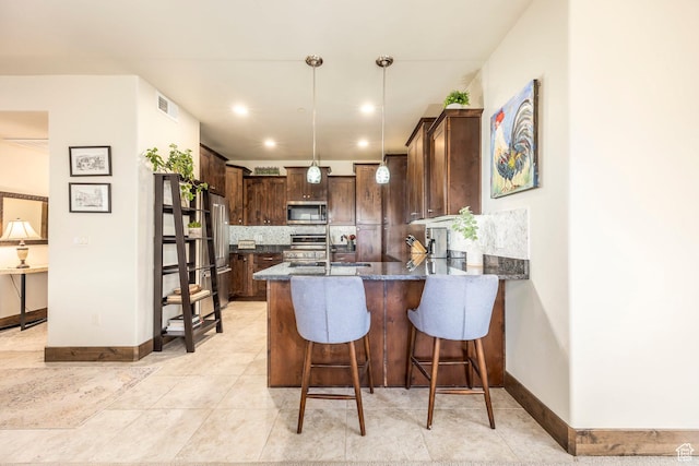 1261 W Black Rock Trl Unit 39F, Kamas, UT 84036 - kitchen featuring stainless steel appliances, dark brown cabinetry, decorative backsplash, a peninsula, and dark stone countertops