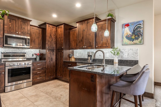 1261 W Black Rock Trl Unit 39F, Kamas, UT 84036 - kitchen with appliances with stainless steel finishes, a peninsula, backsplash, a kitchen breakfast bar, and recessed lighting