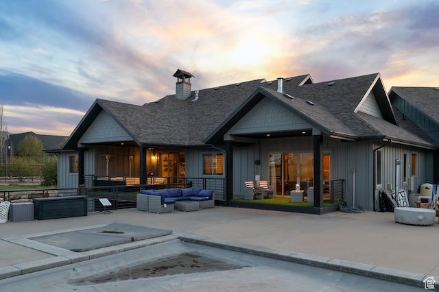 1021 Sage Crk, Heber City, UT 84032 - rear view of property with a shingled roof, an outdoor hangout area, board and batten siding, a chimney, and a patio area