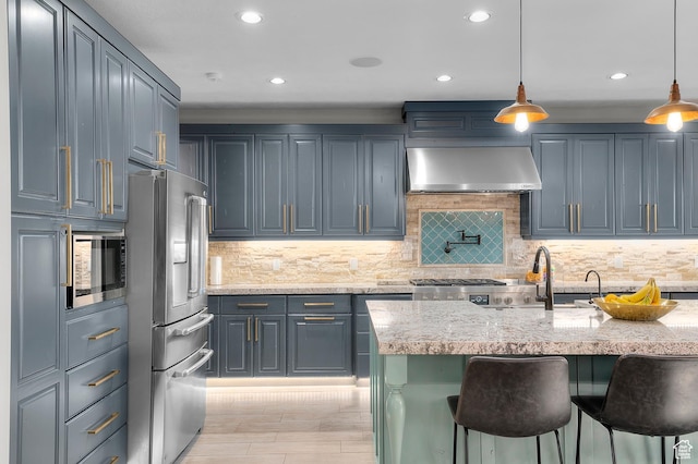 1021 Sage Crk, Heber City, UT 84032 - kitchen featuring wall chimney range hood, a breakfast bar area, appliances with stainless steel finishes, light stone counters, and recessed lighting