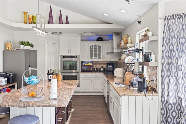 6268 S Faber Ln, Taylorsville, UT 84123 - kitchen featuring ventilation hood, stainless steel appliances, white cabinets, and lofted ceiling