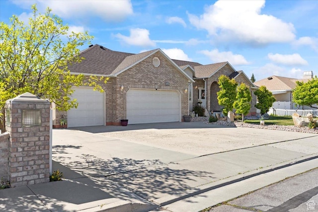 6268 S Faber Ln, Taylorsville, UT 84123 - ranch-style home with driveway, brick siding, fence, an attached garage, and a shingled roof