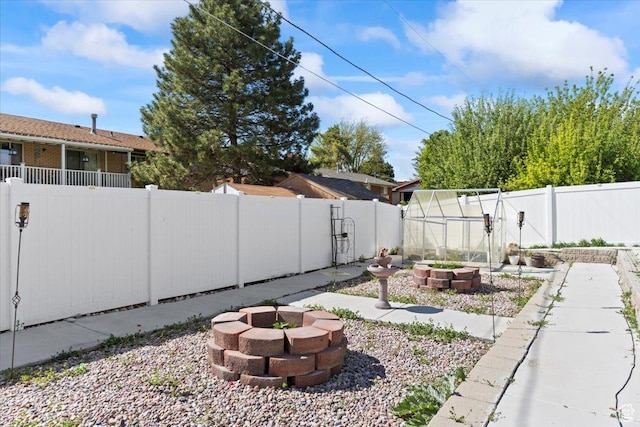 6268 S Faber Ln, Taylorsville, UT 84123 - view of yard with a fenced backyard, an exterior structure, a vegetable garden, an outdoor fire pit, and an outbuilding