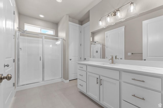 bathroom with a shower stall, tile patterned flooring, vanity, and recessed lighting