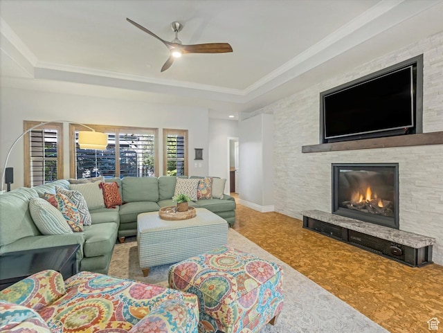 11606 S Radience Ln W, South Jordan, UT 84009 - living room with ceiling fan, ornamental molding, a tray ceiling, and a stone fireplace