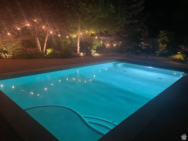 11606 S Radience Ln W, South Jordan, UT 84009 - pool at night featuring an outdoor pool