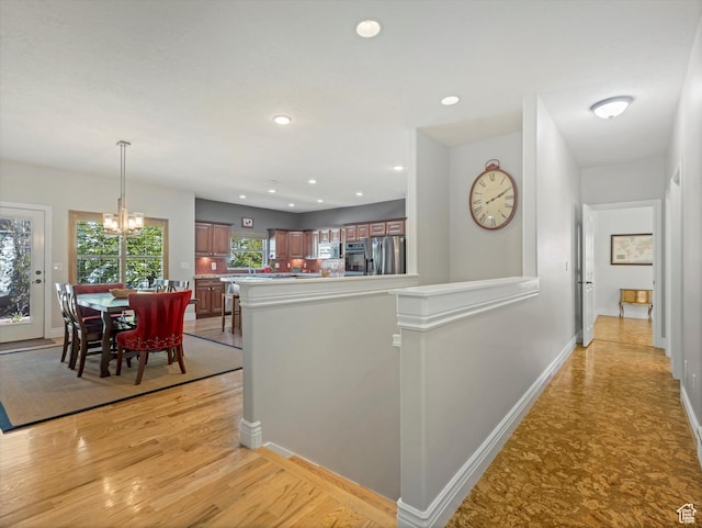11606 S Radience Ln W, South Jordan, UT 84009 - hall featuring recessed lighting, light wood-style flooring, baseboards, and an inviting chandelier