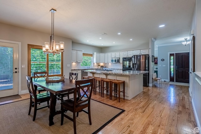 11606 S Radience Ln W, South Jordan, UT 84009 - dining room featuring a chandelier, light wood finished floors, and recessed lighting