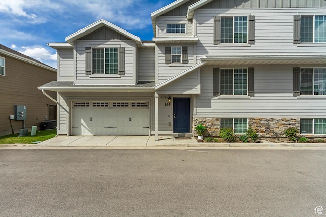 145 E Majestic Elms Pl S, South Salt Lake, UT 84115 - view of front of property with board and batten siding, driveway, and a garage