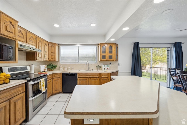 5350 S 3450 W, Roy, UT 84067 - kitchen featuring a healthy amount of sunlight, a textured ceiling, under cabinet range hood, dishwasher, and double oven range