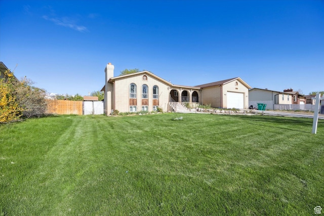 5350 S 3450 W, Roy, UT 84067 - rear view of house featuring fence, a lawn, a chimney, and an attached garage