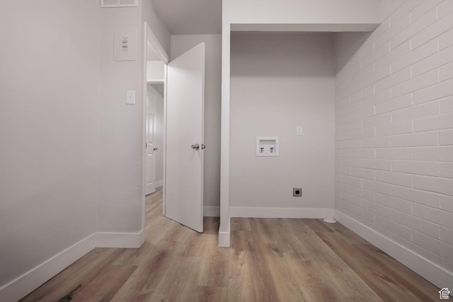 clothes washing area featuring laundry area, baseboards, light wood-style floors, electric dryer hookup, and washer hookup