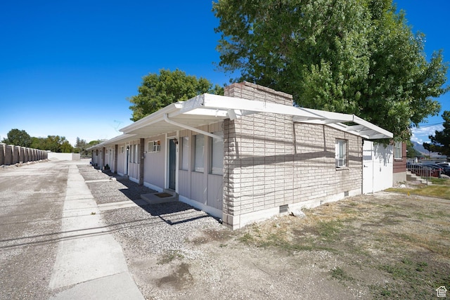 view of side of home featuring fence and a chimney