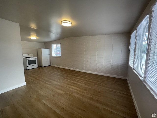 interior space with baseboards and dark wood-type flooring