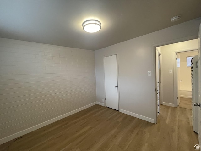 interior space featuring baseboards and light wood-style flooring