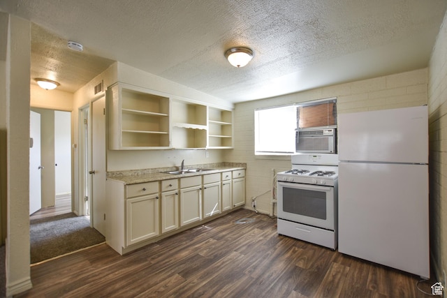 kitchen featuring open shelves, white appliances, dark wood-type flooring, a textured ceiling, and a sink