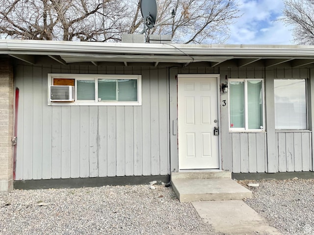 entrance to property with a wall mounted air conditioner