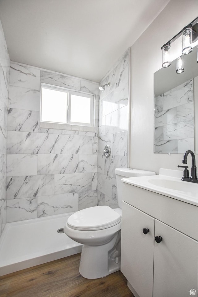 full bathroom with vanity, walk in shower, toilet, and wood finished floors