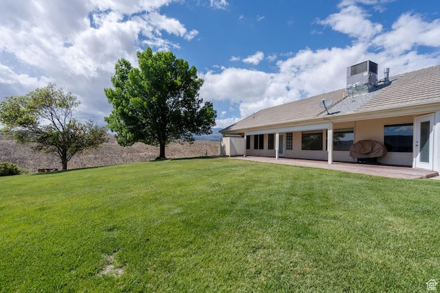 view of yard with a patio and central AC unit