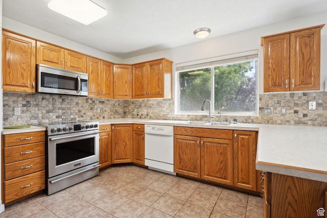 kitchen with light countertops, appliances with stainless steel finishes, and a sink