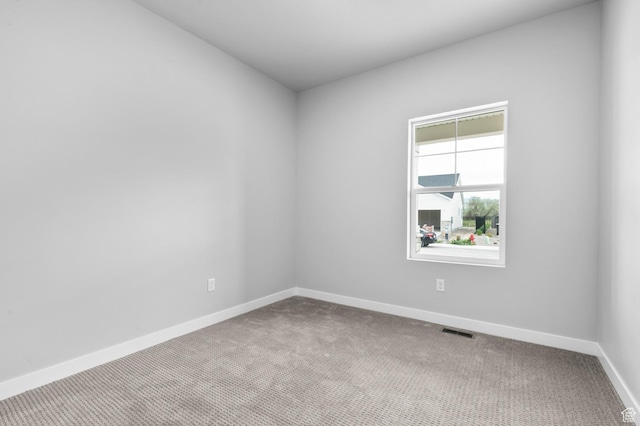 unfurnished room featuring carpet flooring and baseboards