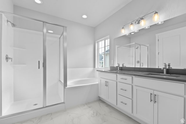 full bath with marble look tiles, a stall shower, double vanity, recessed lighting, and a garden tub