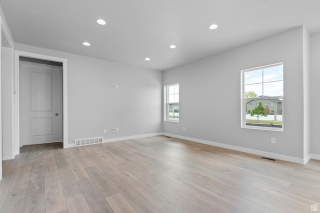 unfurnished room featuring recessed lighting, light wood-style floors, and baseboards