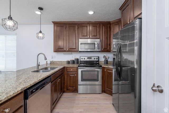 2046 W 1100 N, Provo, UT 84604 - kitchen with a sink, light stone counters, stainless steel appliances, and light wood finished floors