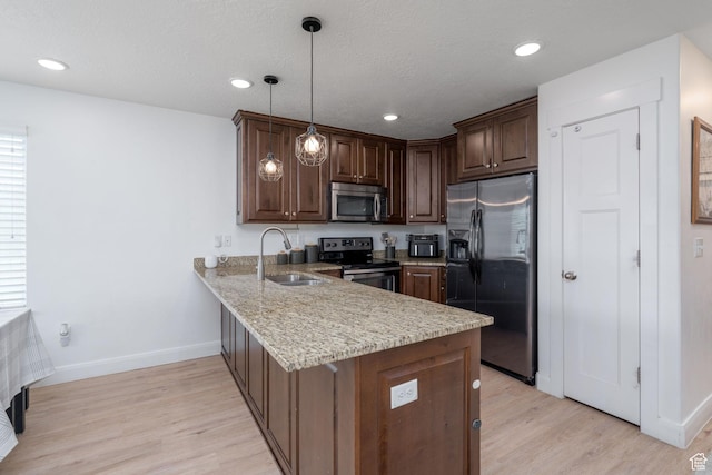 2046 W 1100 N, Provo, UT 84604 - kitchen with a sink, baseboards, light wood finished floors, a peninsula, and stainless steel appliances