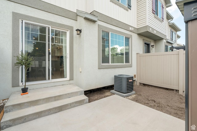 2046 W 1100 N, Provo, UT 84604 - doorway to property featuring fence, a patio, stucco siding, and central AC unit