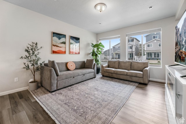 134 E Stroll Ave Unit 816, Saratoga Springs, UT 84045 - living room featuring baseboards and wood finished floors
