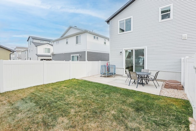 134 E Stroll Ave Unit 816, Saratoga Springs, UT 84045 - rear view of property featuring a lawn, a trampoline, a patio area, and fence