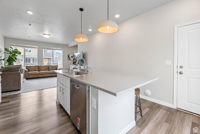 134 E Stroll Ave Unit 816, Saratoga Springs, UT 84045 - kitchen featuring a sink, an island with sink, light wood-type flooring, stainless steel dishwasher, and pendant lighting