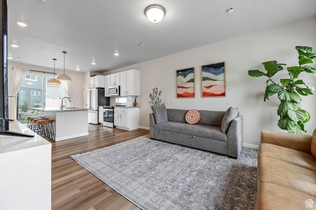 134 E Stroll Ave Unit 816, Saratoga Springs, UT 84045 - living room with recessed lighting, baseboards, and dark wood-style floors