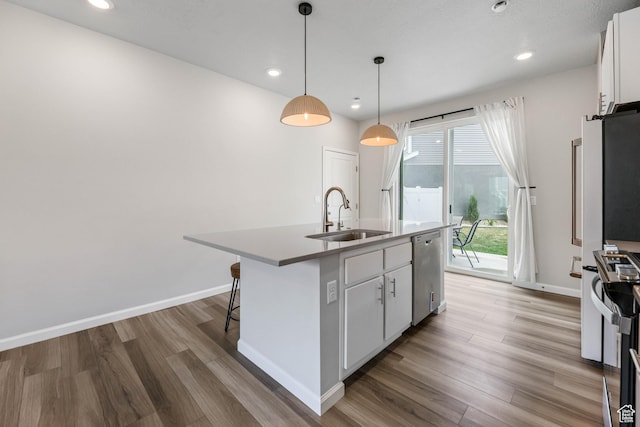 134 E Stroll Ave Unit 816, Saratoga Springs, UT 84045 - kitchen with appliances with stainless steel finishes, a sink, light wood finished floors, a kitchen island with sink, and white cabinetry