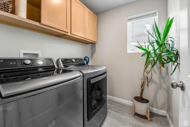 134 E Stroll Ave Unit 816, Saratoga Springs, UT 84045 - laundry area with baseboards, light wood-type flooring, cabinet space, and washer and dryer