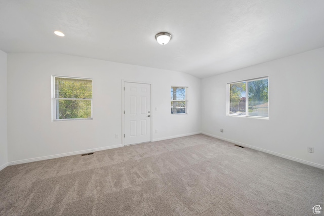 carpeted empty room featuring baseboards