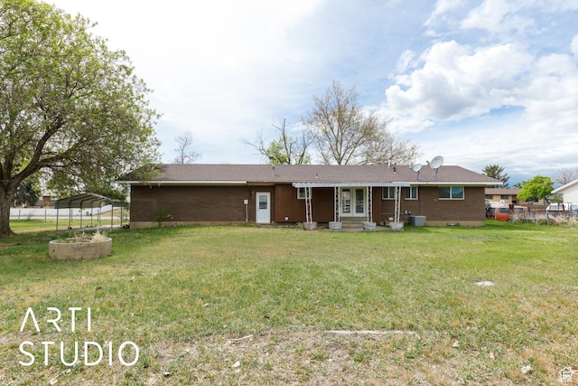 2732 S 4550 W, Taylor, UT 84401 - back of house featuring a detached carport, central AC, fence, brick siding, and a lawn