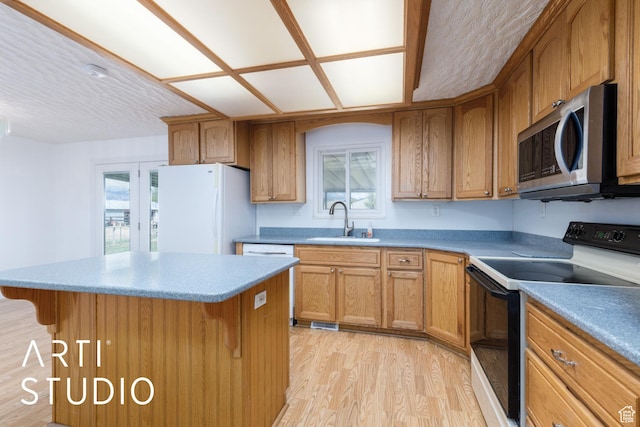 2732 S 4550 W, Taylor, UT 84401 - kitchen featuring light wood-type flooring, a sink, stainless steel microwave, freestanding refrigerator, and black range with electric cooktop