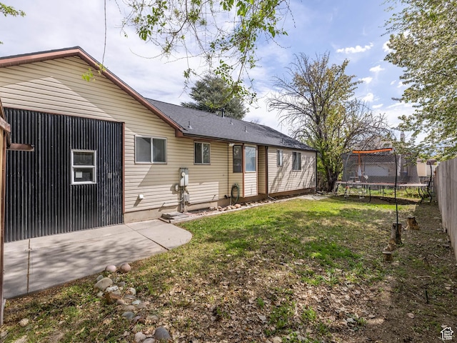 2265 W Marvinwood Dr S, Taylorsville, UT 84129 - rear view of house with fence, a trampoline, a yard, and a patio