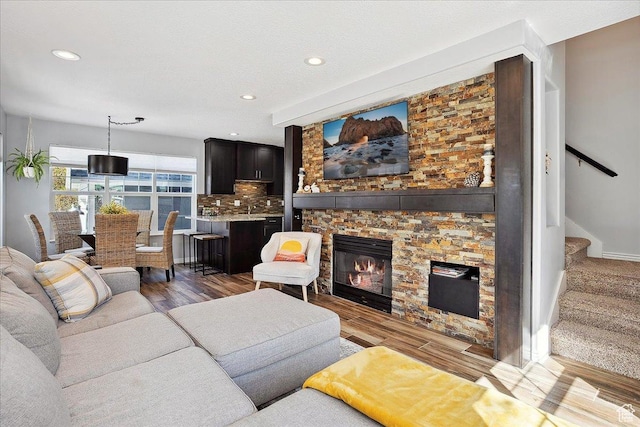 3511 N Willow Creek Ln E Unit 10, Eden, UT 84310 - living room featuring stairway, a stone fireplace, recessed lighting, and wood finished floors