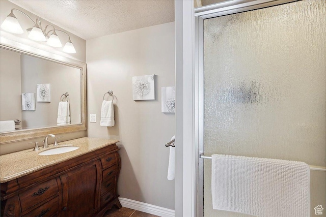 3511 N Willow Creek Ln E Unit 10, Eden, UT 84310 - full bath featuring a textured ceiling, baseboards, a shower with shower door, and vanity