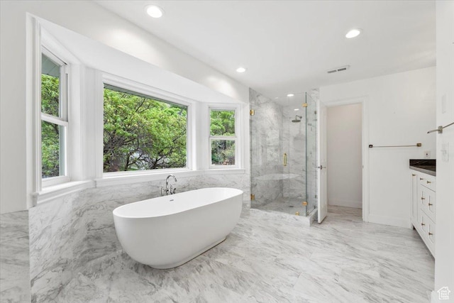 bathroom with visible vents, a marble finish shower, a freestanding tub, and a healthy amount of sunlight