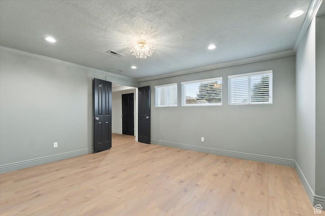 unfurnished room with ornamental molding, recessed lighting, visible vents, and light wood-style floors