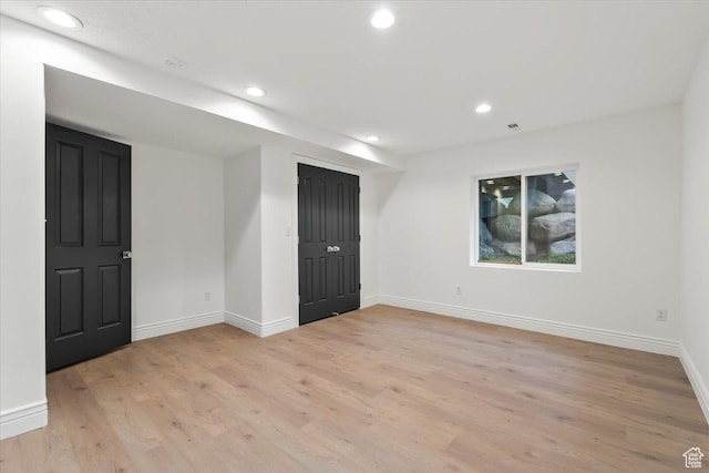 unfurnished room with light wood-style floors, baseboards, and recessed lighting